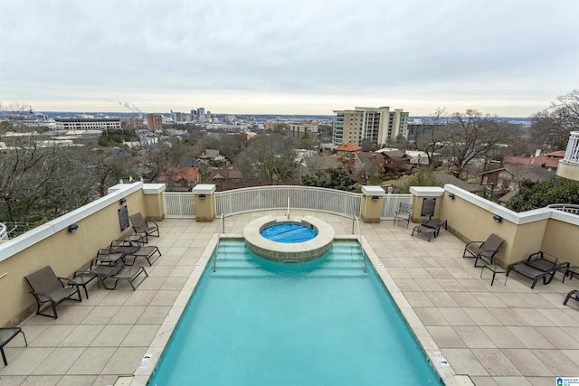 view of swimming pool with a patio area and a community hot tub