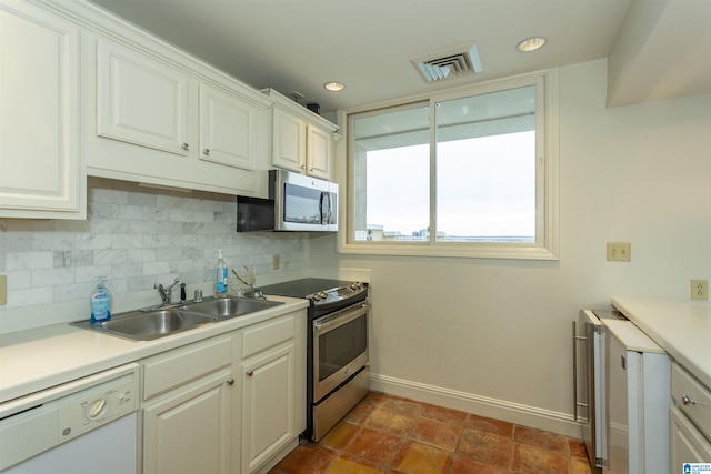 kitchen with sink, white cabinetry, and stainless steel appliances