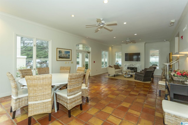 dining space with ceiling fan, french doors, and ornamental molding