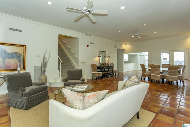 living room with ceiling fan, ornamental molding, and tile patterned flooring