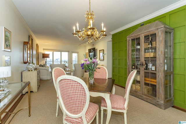 carpeted dining room featuring crown molding and a notable chandelier