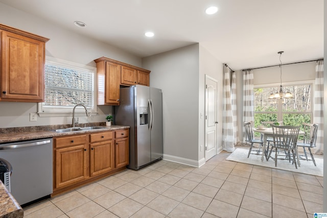 kitchen featuring light tile patterned floors, appliances with stainless steel finishes, plenty of natural light, and sink