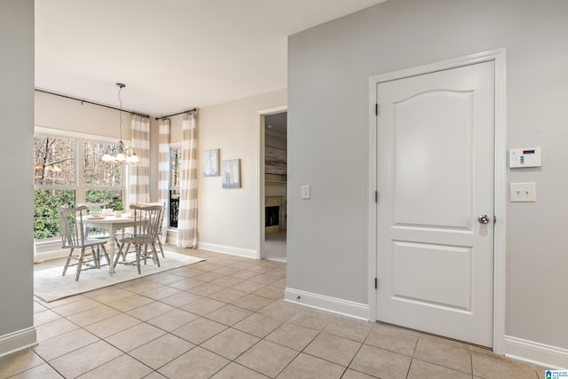 unfurnished dining area with light tile patterned floors and a chandelier