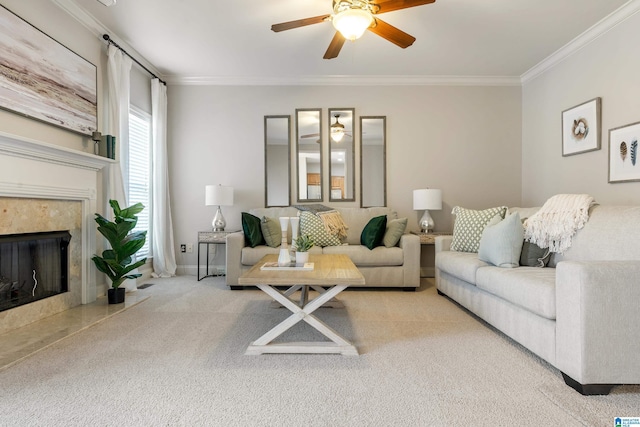 carpeted living room featuring ceiling fan, ornamental molding, and a premium fireplace