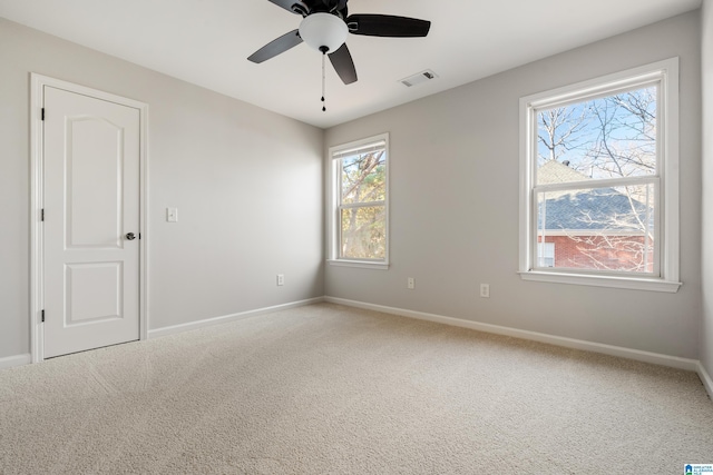 spare room with carpet and ceiling fan