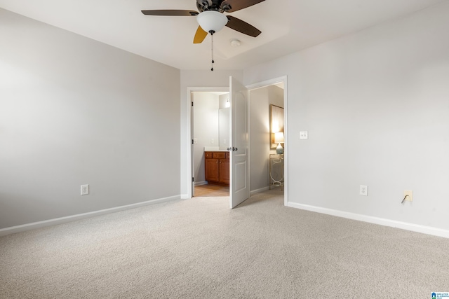 spare room with ceiling fan and light carpet