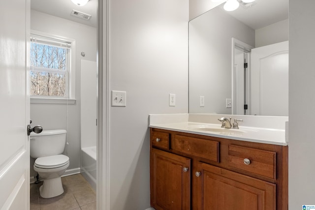 bathroom with toilet, tile patterned floors, and vanity