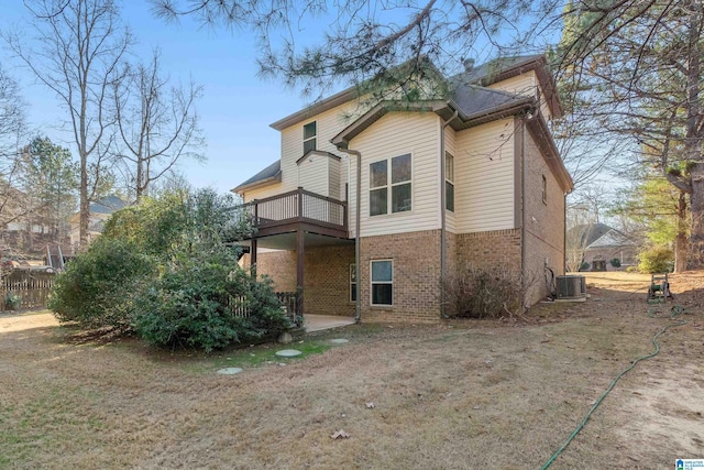 back of property with cooling unit and a balcony