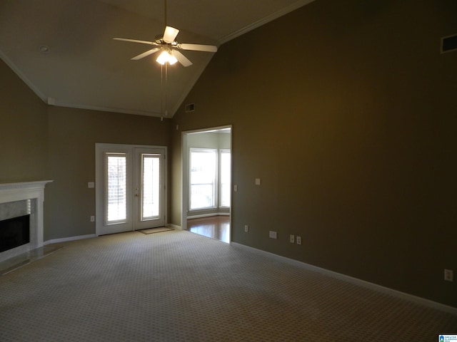 unfurnished living room with a high end fireplace, high vaulted ceiling, carpet flooring, ceiling fan, and crown molding