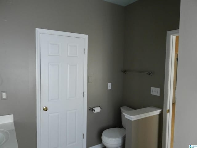 bathroom featuring toilet and vanity