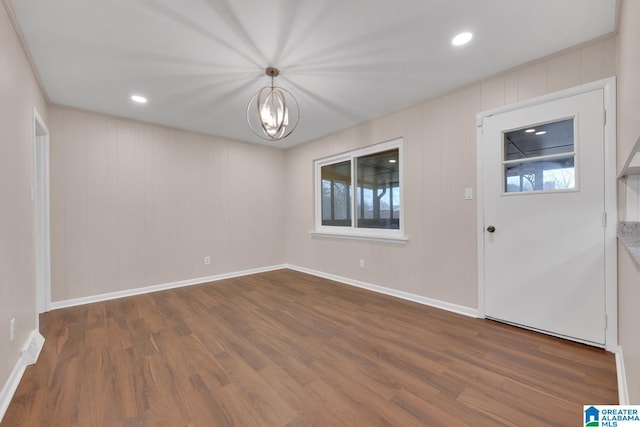 foyer with dark hardwood / wood-style flooring and an inviting chandelier