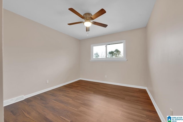 unfurnished room with ceiling fan and dark wood-type flooring