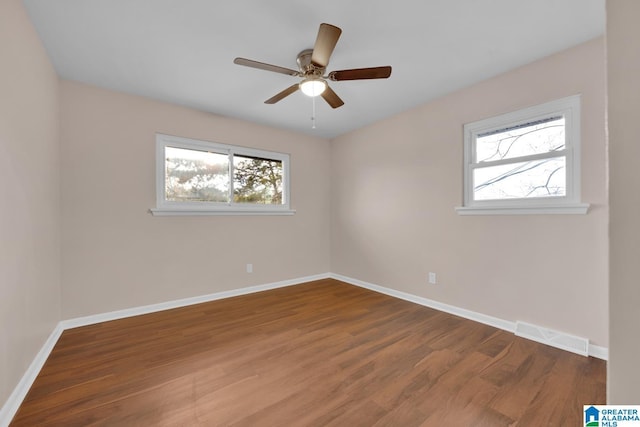 spare room with ceiling fan and wood-type flooring