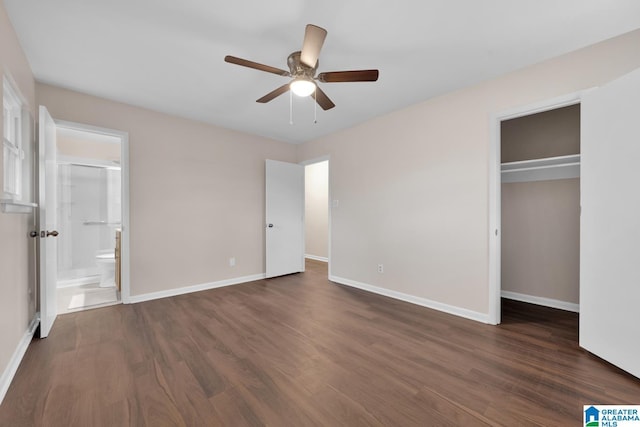 unfurnished bedroom with dark wood-type flooring, a closet, ensuite bath, and ceiling fan