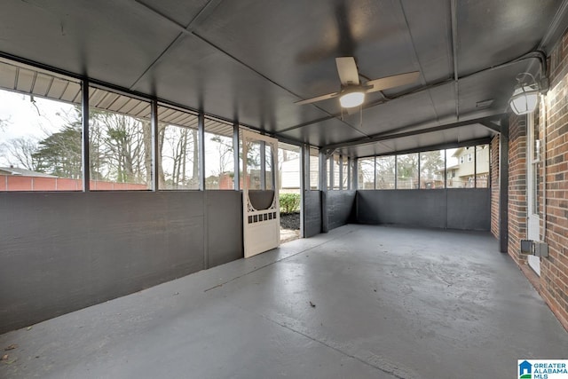 unfurnished sunroom featuring ceiling fan