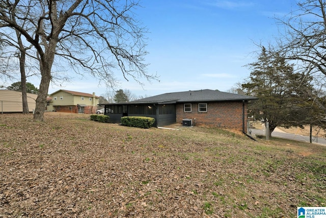 rear view of property featuring cooling unit and a sunroom