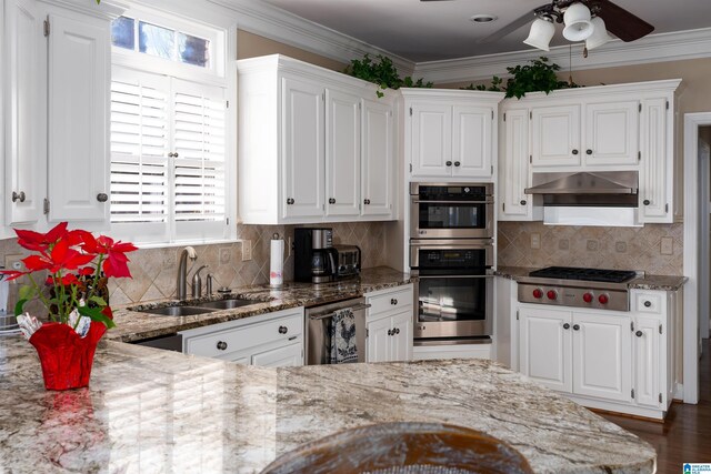 kitchen featuring sink, white cabinetry, stainless steel appliances, and tasteful backsplash