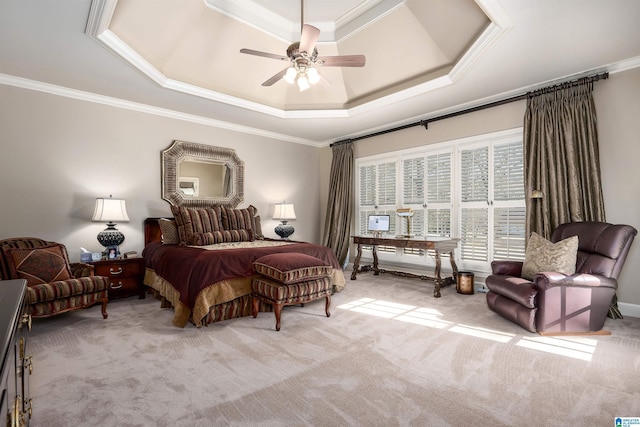 bedroom featuring ceiling fan, a tray ceiling, ornamental molding, and light carpet