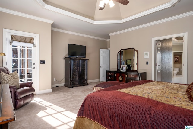 bedroom featuring ensuite bathroom, ceiling fan, a raised ceiling, light colored carpet, and ornamental molding