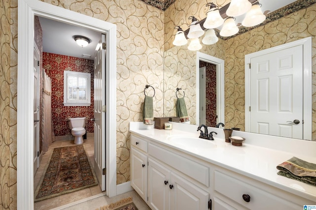 bathroom featuring toilet, tile patterned floors, and vanity