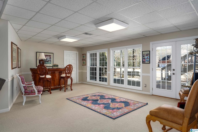 sitting room with french doors, carpet, bar area, and a drop ceiling