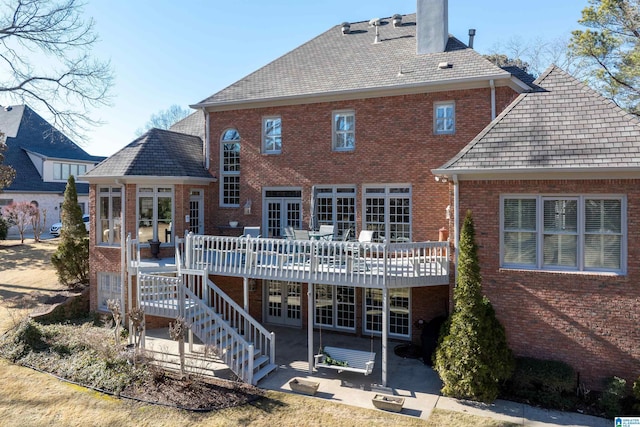 rear view of property with a patio area and a wooden deck