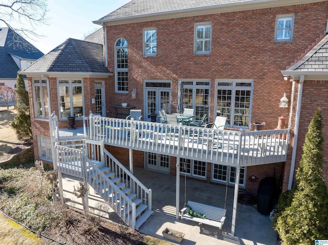 rear view of house featuring a patio area and a wooden deck