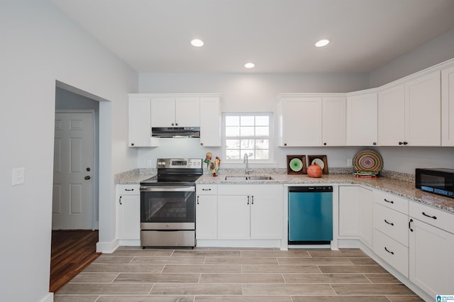 kitchen featuring sink, stainless steel appliances, white cabinetry, and light stone counters