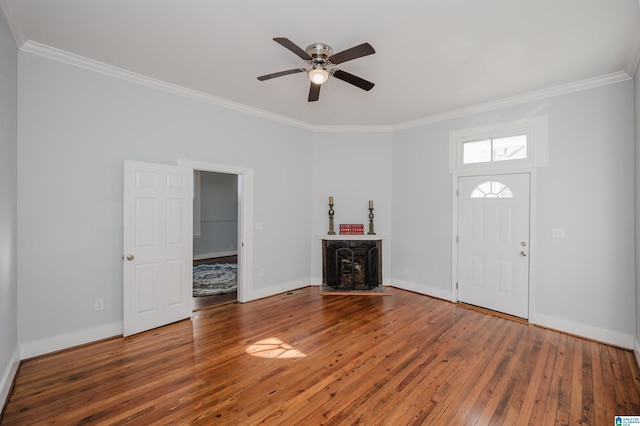 foyer featuring ceiling fan, crown molding, and wood-type flooring