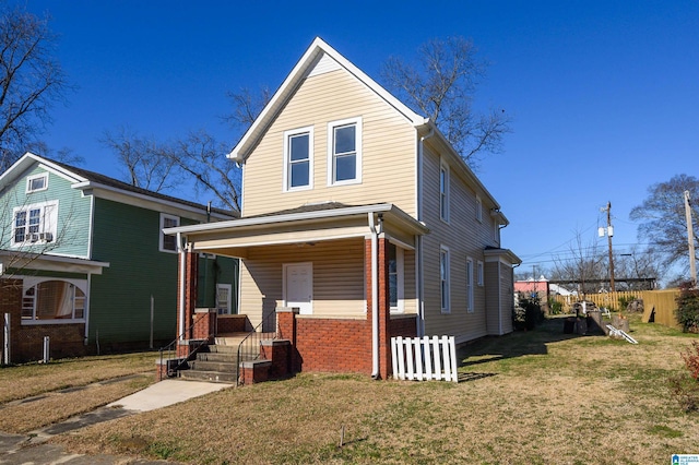 front facade with covered porch and a front yard