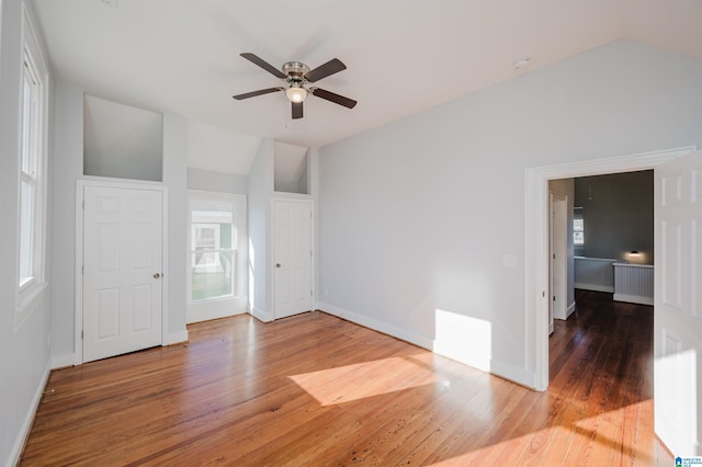 unfurnished room featuring ceiling fan, hardwood / wood-style floors, and lofted ceiling