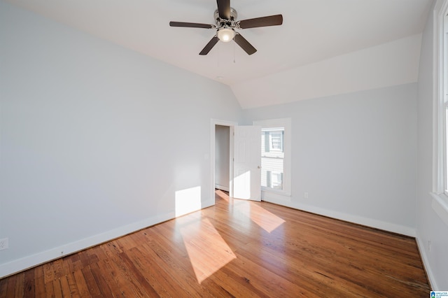 spare room with ceiling fan, hardwood / wood-style floors, and vaulted ceiling