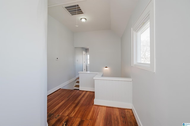 hallway featuring dark hardwood / wood-style floors and lofted ceiling