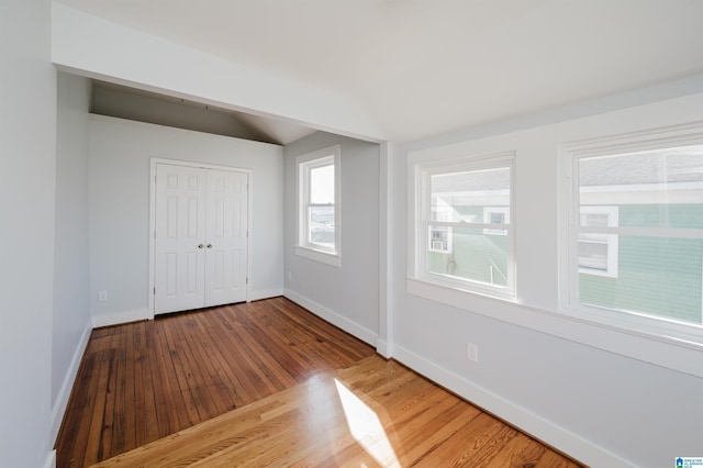 unfurnished bedroom with a closet and hardwood / wood-style flooring