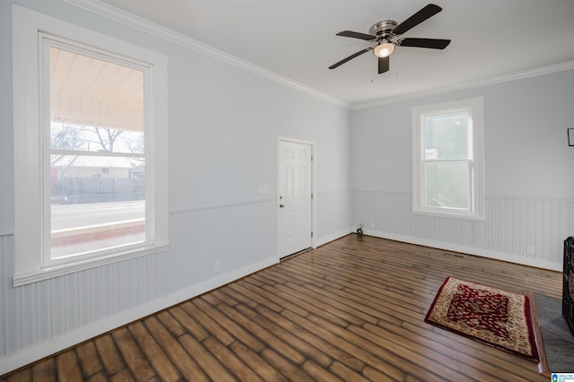 empty room with dark hardwood / wood-style flooring, ceiling fan, and ornamental molding