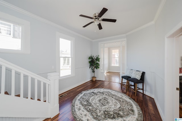 entryway featuring ceiling fan, crown molding, and dark hardwood / wood-style floors