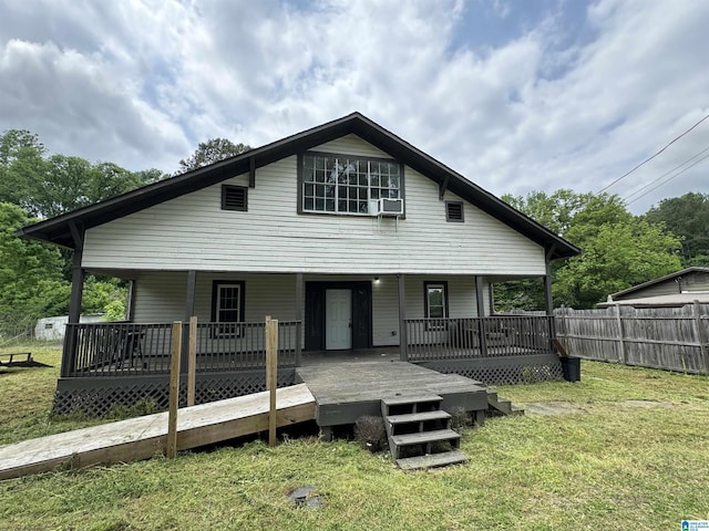 view of front of house with a front yard, cooling unit, and a deck