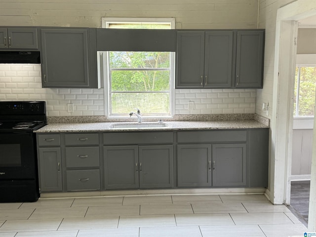 kitchen with extractor fan, tasteful backsplash, sink, gray cabinets, and black electric range oven