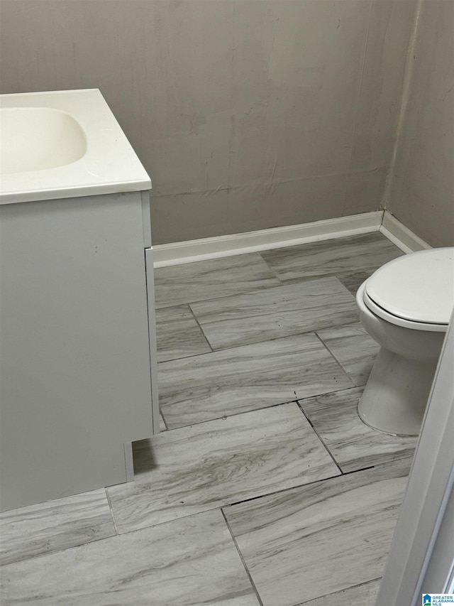 bathroom featuring tile patterned floors, toilet, and vanity