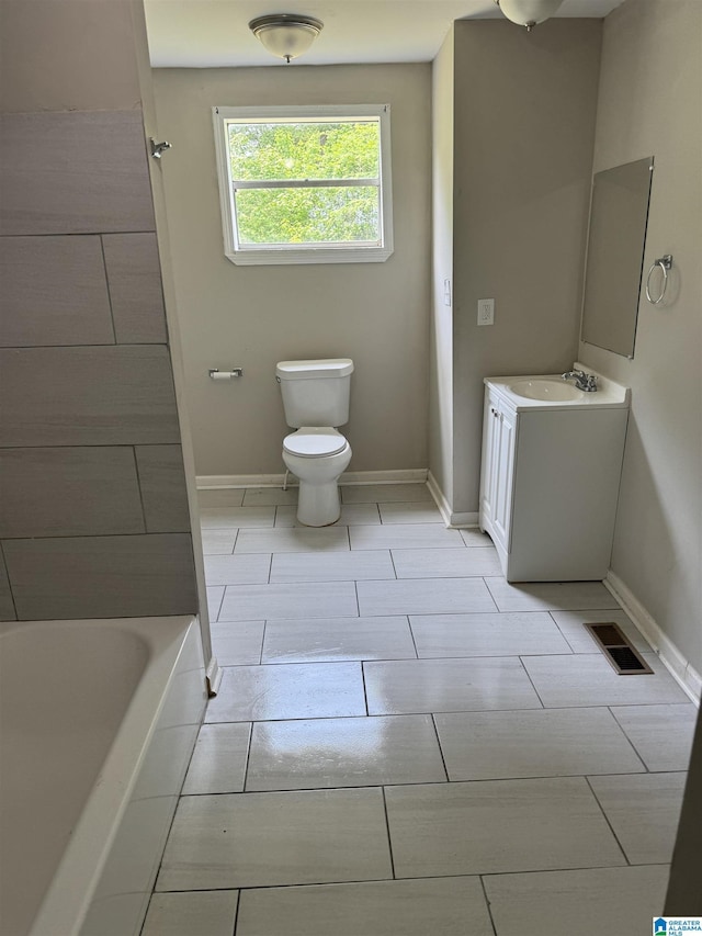 bathroom with vanity, toilet, and tile patterned flooring