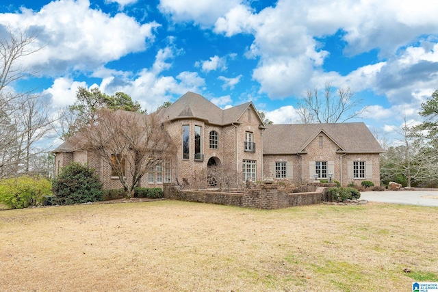 french provincial home with a front yard