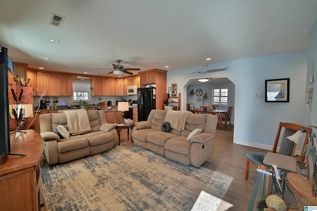 living room featuring ceiling fan and hardwood / wood-style floors