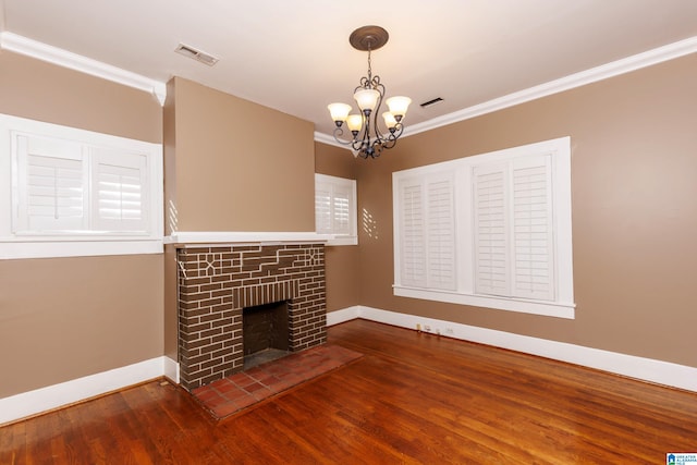 unfurnished living room with hardwood / wood-style floors, crown molding, and a fireplace