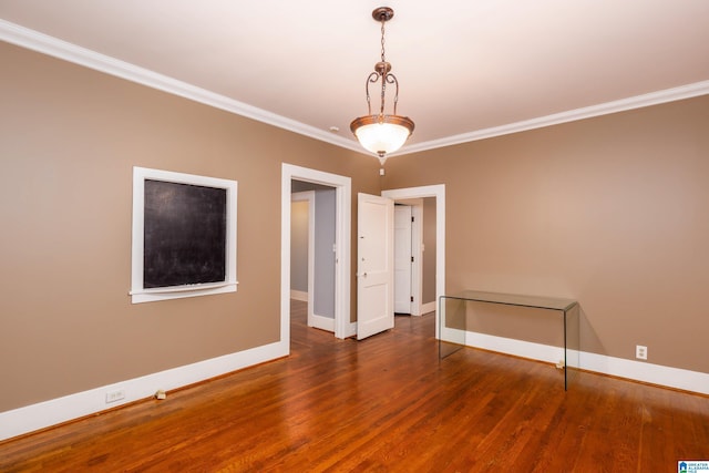 spare room with dark hardwood / wood-style flooring and ornamental molding