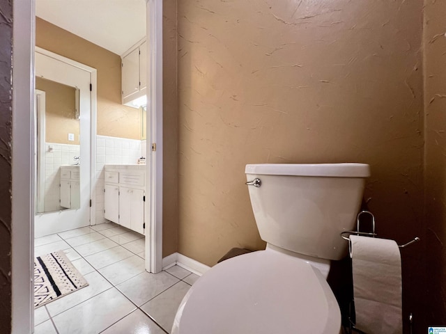 bathroom with toilet and tile patterned floors