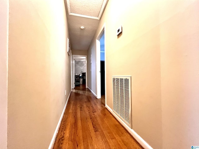 corridor with wood-type flooring