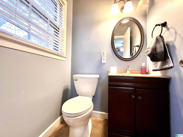 bathroom with vanity, toilet, and tile patterned floors