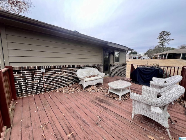 wooden terrace with a grill