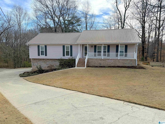 ranch-style house with covered porch and a front lawn