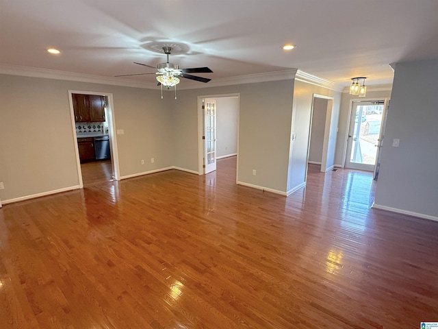 empty room with ceiling fan, dark hardwood / wood-style floors, and crown molding